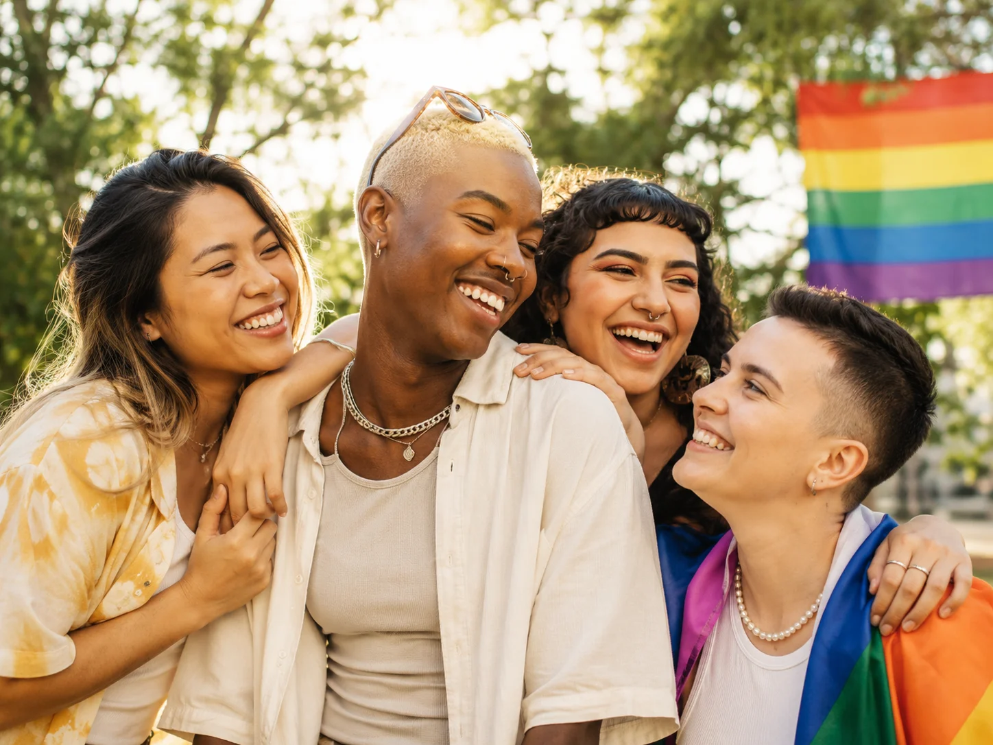 A diverse group of LGBTQ+ friends spending time together outdoors.